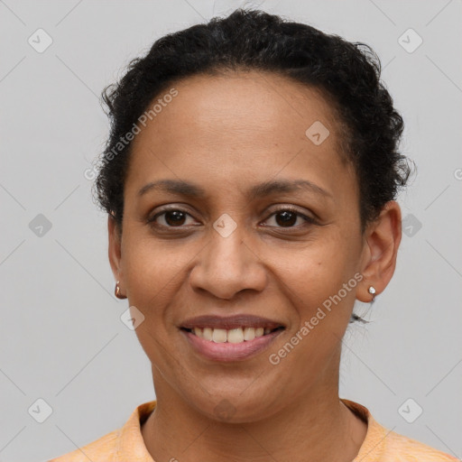 Joyful latino adult female with short  brown hair and brown eyes