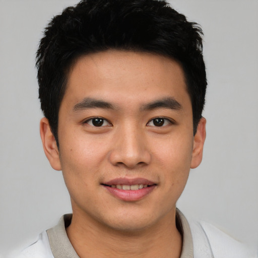 Joyful asian young-adult male with short  black hair and brown eyes