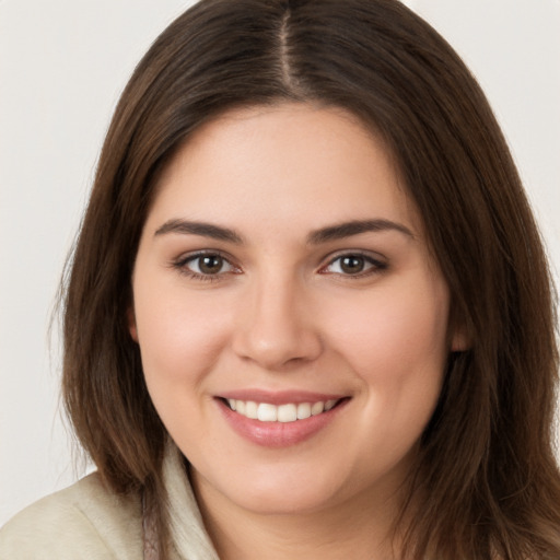 Joyful white young-adult female with long  brown hair and brown eyes