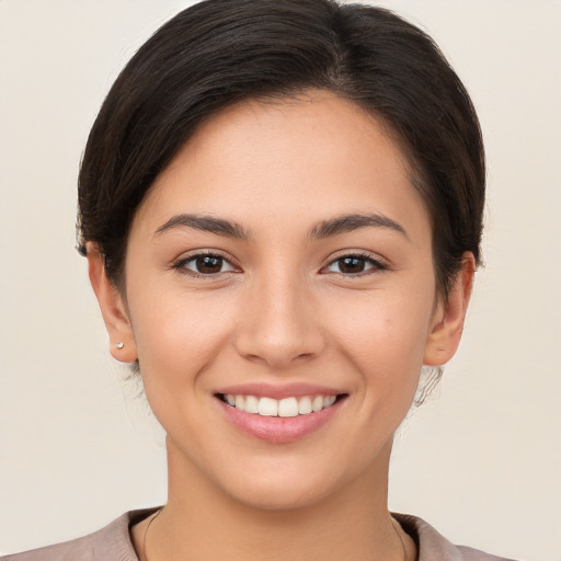 Joyful white young-adult female with short  brown hair and brown eyes