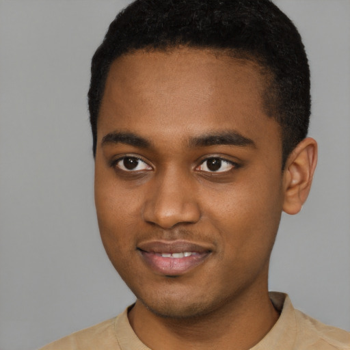 Joyful black young-adult male with short  black hair and brown eyes