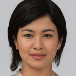 Joyful asian young-adult female with medium  black hair and brown eyes