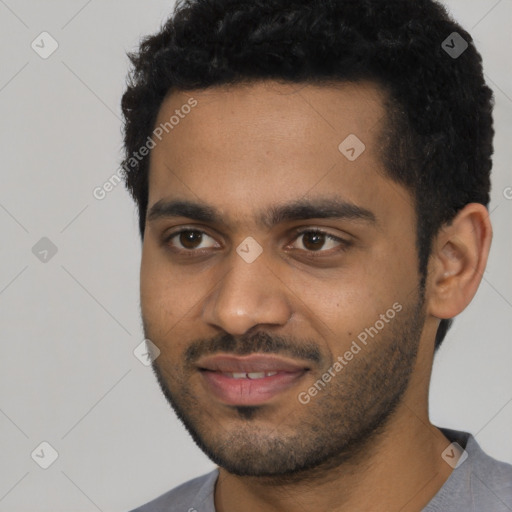 Joyful black young-adult male with short  black hair and brown eyes