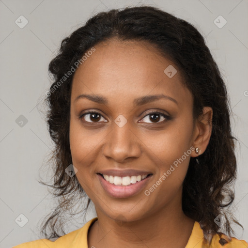 Joyful black young-adult female with long  brown hair and brown eyes