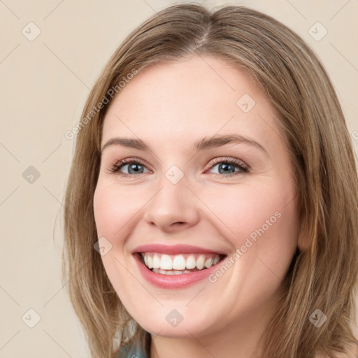 Joyful white young-adult female with medium  brown hair and green eyes