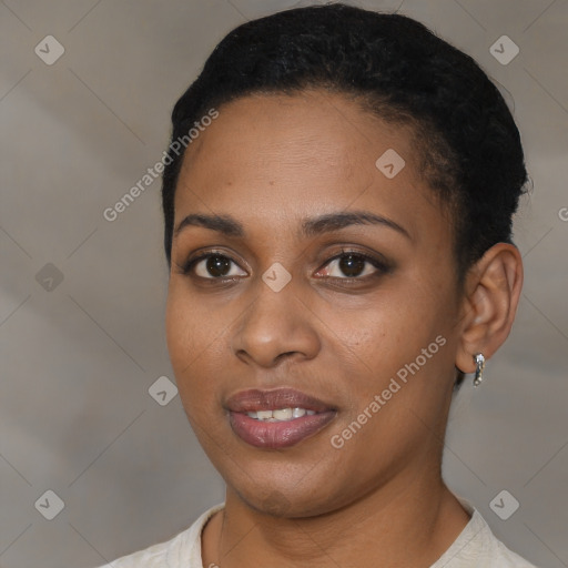 Joyful black young-adult female with short  black hair and brown eyes