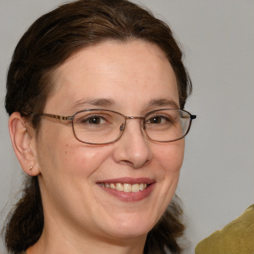 Joyful white adult female with medium  brown hair and grey eyes