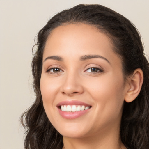 Joyful white young-adult female with long  brown hair and brown eyes