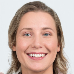 Joyful white young-adult female with long  brown hair and blue eyes