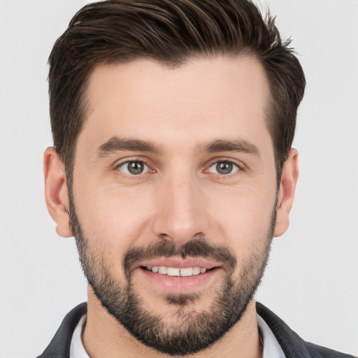 Joyful white young-adult male with short  brown hair and brown eyes