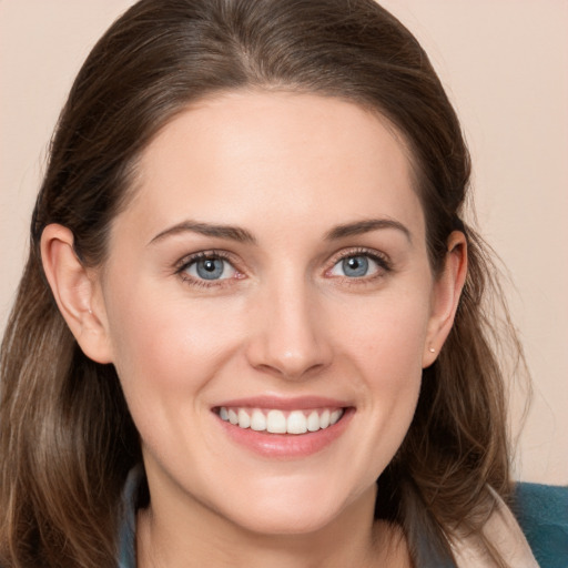 Joyful white young-adult female with long  brown hair and grey eyes