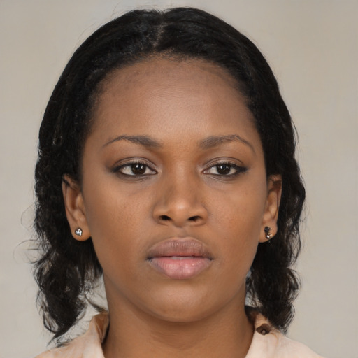 Neutral black young-adult female with medium  brown hair and brown eyes