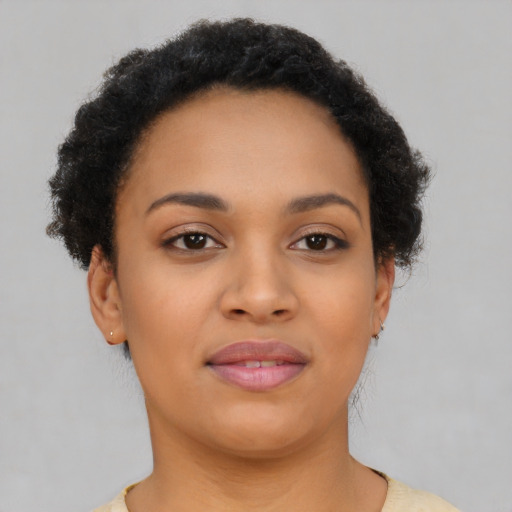 Joyful black young-adult female with short  brown hair and brown eyes