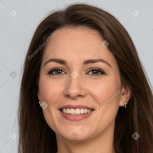 Joyful white adult female with long  brown hair and brown eyes