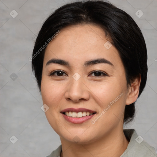 Joyful asian young-adult female with medium  brown hair and brown eyes