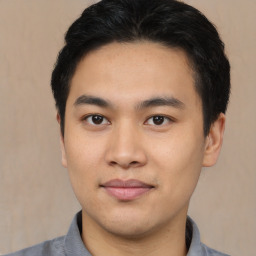 Joyful asian young-adult male with short  brown hair and brown eyes