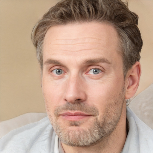 Joyful white adult male with short  brown hair and grey eyes