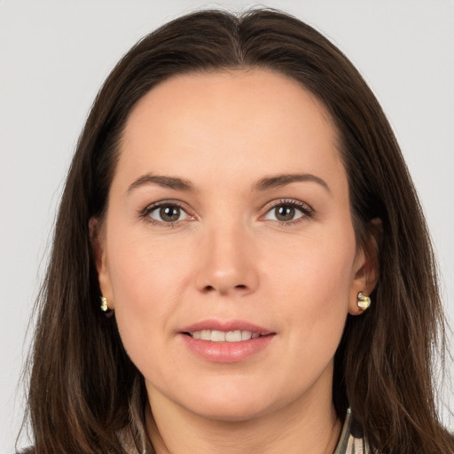 Joyful white young-adult female with long  brown hair and brown eyes