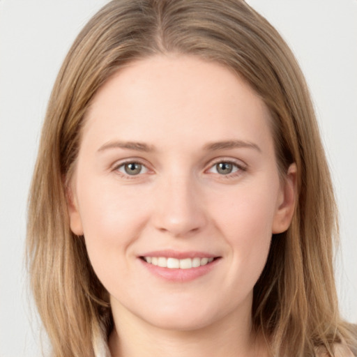 Joyful white young-adult female with long  brown hair and grey eyes