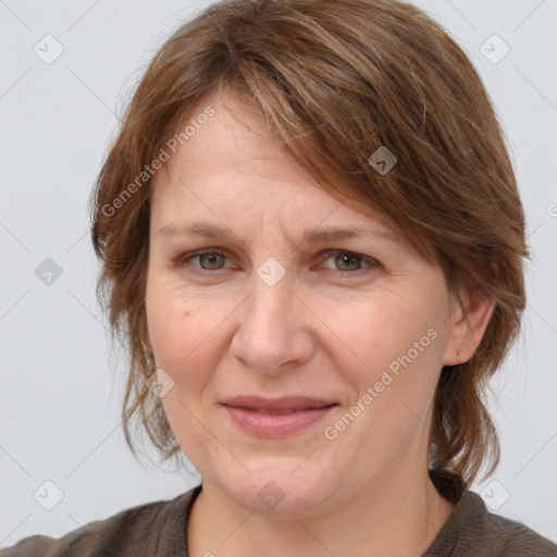 Joyful white adult female with medium  brown hair and grey eyes