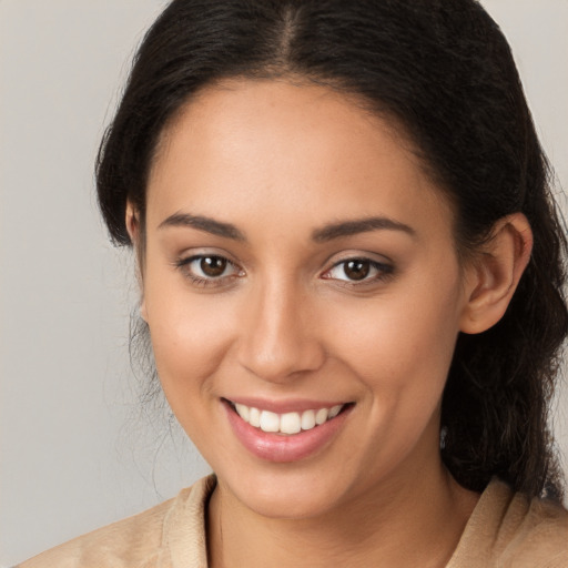 Joyful white young-adult female with long  brown hair and brown eyes