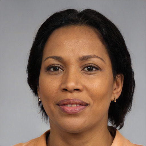 Joyful black adult female with medium  brown hair and brown eyes