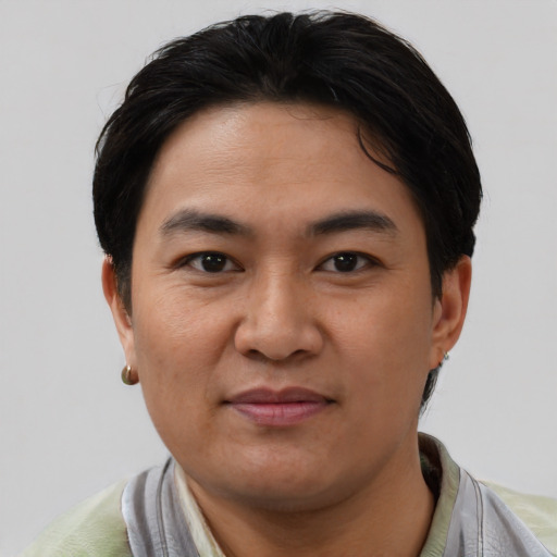Joyful asian young-adult male with short  brown hair and brown eyes