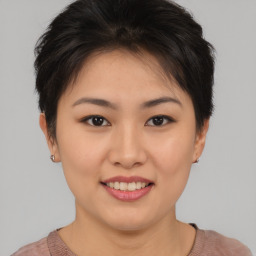 Joyful asian young-adult female with short  brown hair and brown eyes