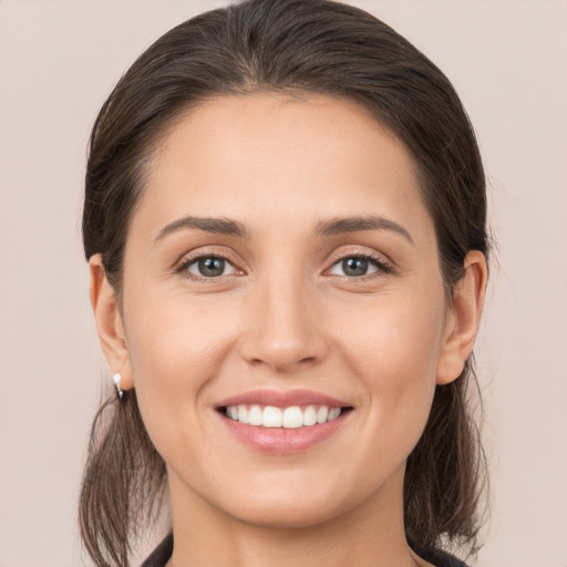 Joyful white young-adult female with medium  brown hair and brown eyes