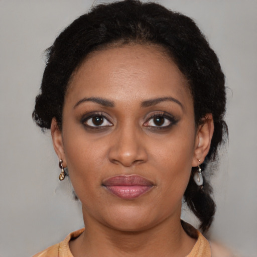 Joyful black young-adult female with medium  brown hair and brown eyes