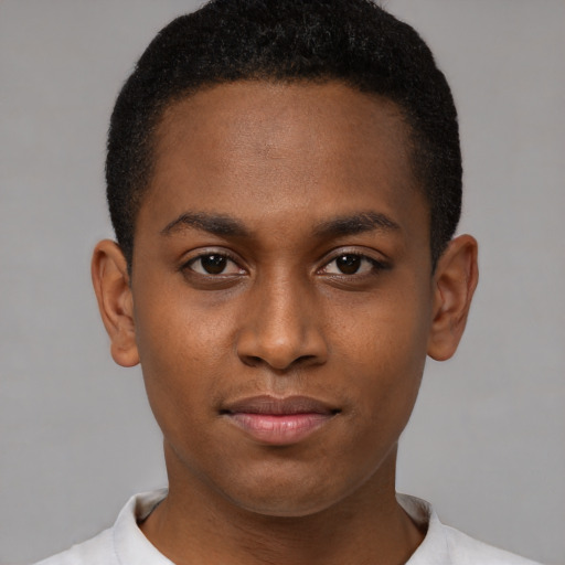 Joyful black young-adult male with short  black hair and brown eyes
