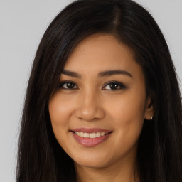 Joyful latino young-adult female with long  brown hair and brown eyes