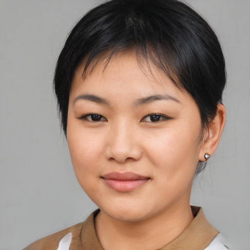 Joyful asian young-adult female with medium  brown hair and brown eyes