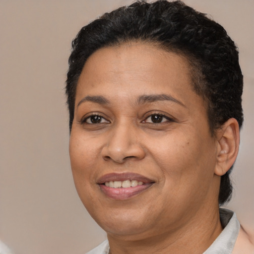 Joyful latino adult female with short  brown hair and brown eyes
