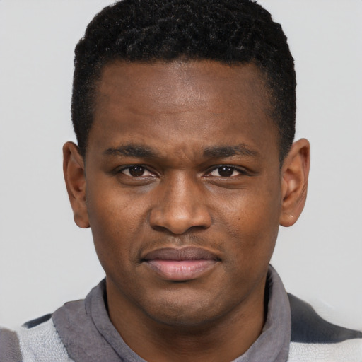 Joyful black young-adult male with short  brown hair and brown eyes