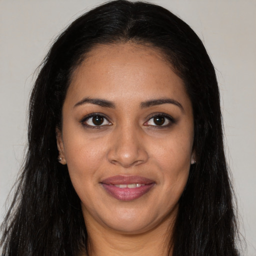 Joyful latino young-adult female with long  black hair and brown eyes