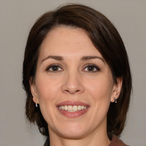 Joyful white adult female with medium  brown hair and brown eyes