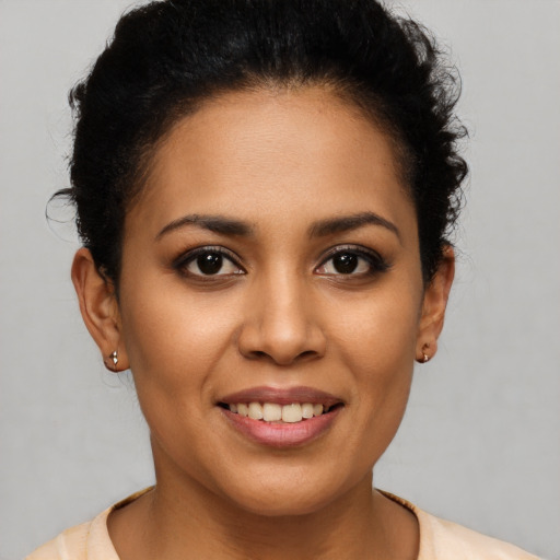 Joyful latino young-adult female with short  brown hair and brown eyes