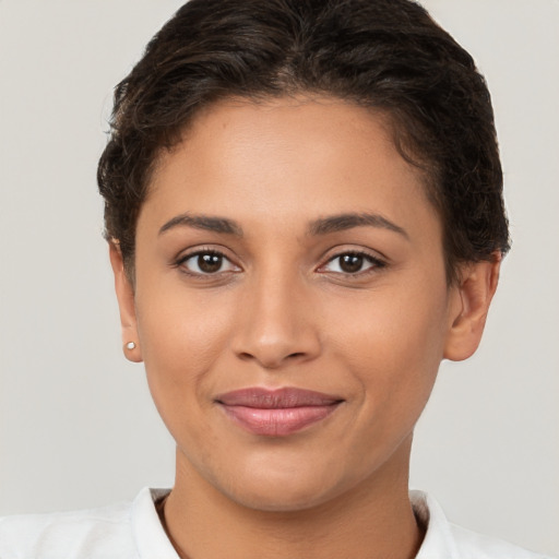 Joyful latino young-adult female with short  brown hair and brown eyes