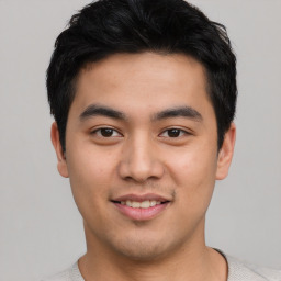 Joyful asian young-adult male with short  brown hair and brown eyes