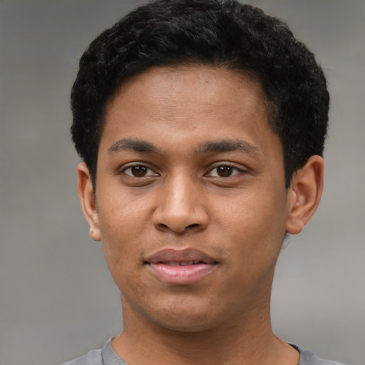 Joyful latino young-adult male with short  brown hair and brown eyes