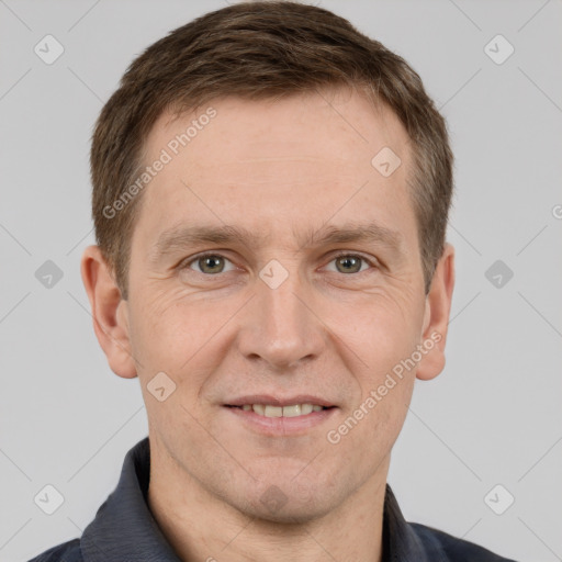 Joyful white adult male with short  brown hair and grey eyes