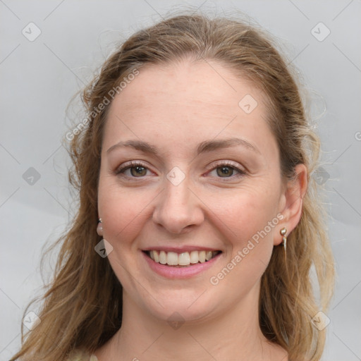 Joyful white young-adult female with long  brown hair and blue eyes