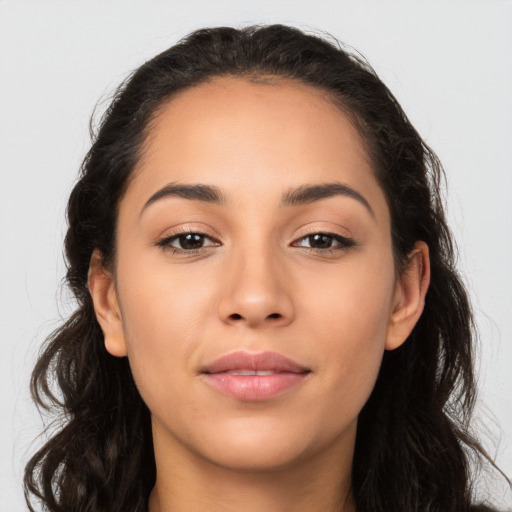 Joyful latino young-adult female with long  brown hair and brown eyes