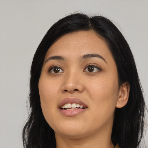 Joyful asian young-adult female with long  black hair and brown eyes