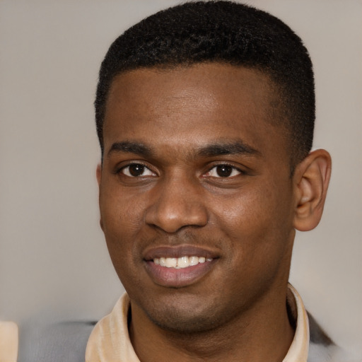 Joyful black young-adult male with short  brown hair and brown eyes