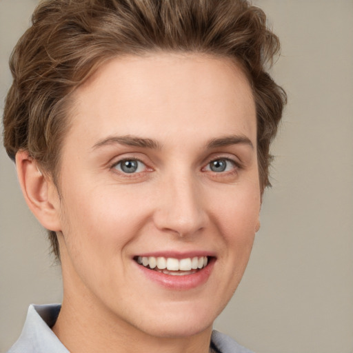 Joyful white young-adult female with short  brown hair and grey eyes