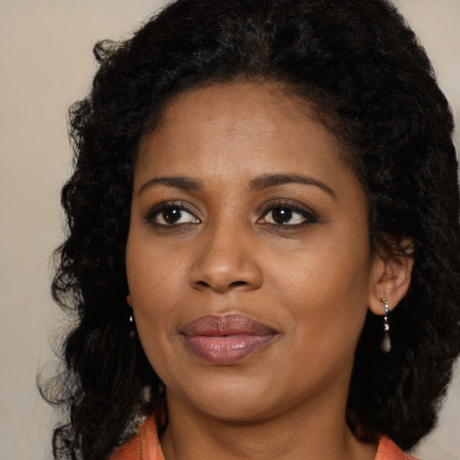 Joyful black young-adult female with medium  black hair and brown eyes