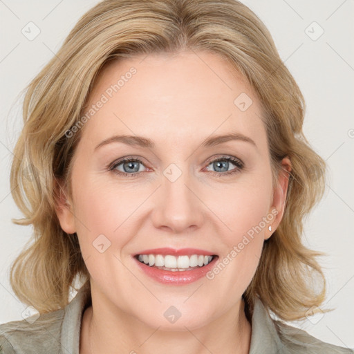 Joyful white young-adult female with medium  brown hair and blue eyes