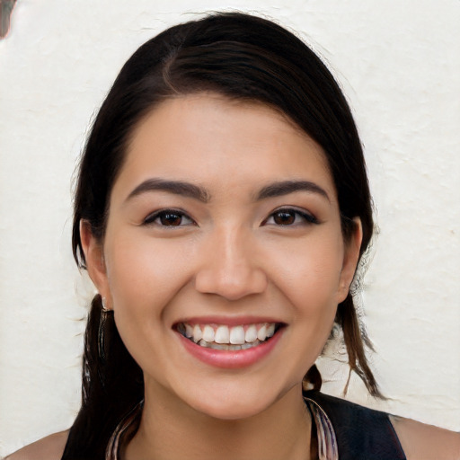 Joyful white young-adult female with long  black hair and brown eyes